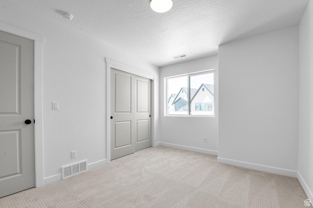 2415 N Ribe Ln, Lehi, UT 84043 - unfurnished bedroom featuring light colored carpet, a textured ceiling, baseboards, and a closet