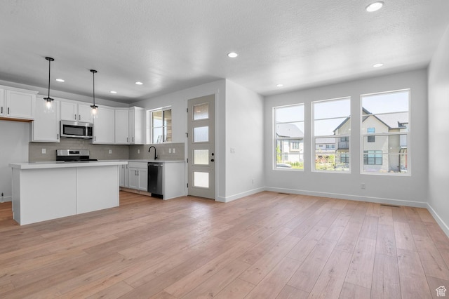 2415 N Ribe Ln, Lehi, UT 84043 - kitchen featuring appliances with stainless steel finishes, light countertops, backsplash, white cabinetry, and baseboards
