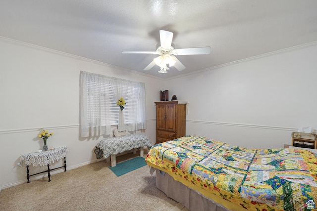 carpeted bedroom featuring ornamental molding and ceiling fan