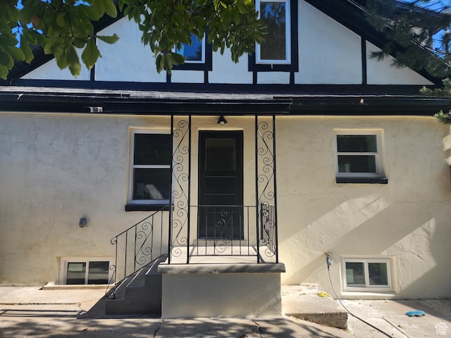 entrance to property featuring stucco siding