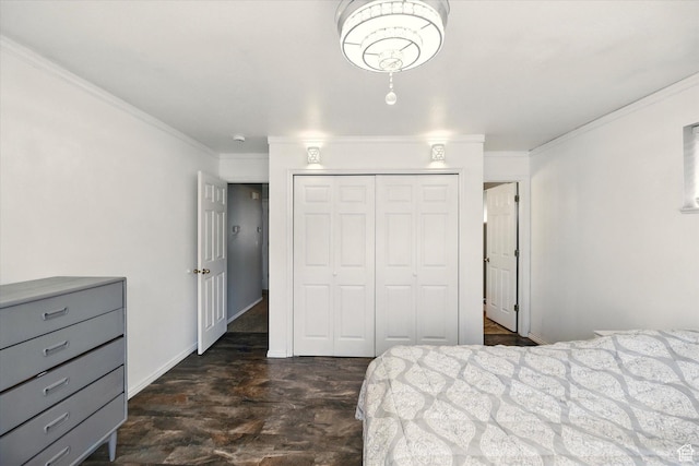 bedroom featuring a closet, ornamental molding, dark wood-type flooring, and baseboards