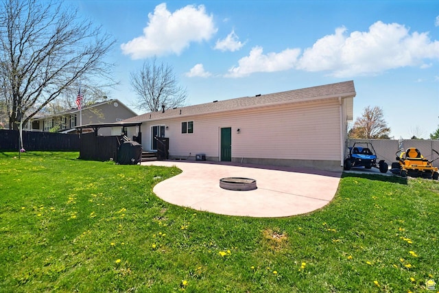 rear view of property featuring a patio and an outdoor fire pit