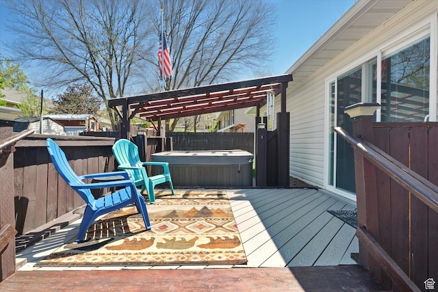 wooden terrace with a hot tub, a fenced backyard, and a pergola