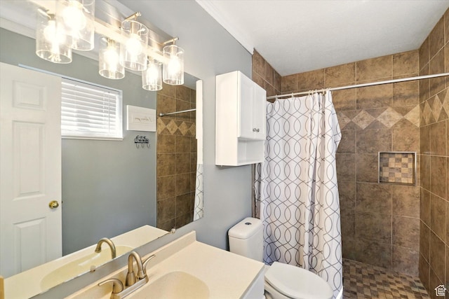 bathroom featuring tiled shower, vanity, and toilet
