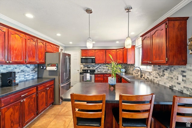kitchen featuring stainless steel appliances, a sink, reddish brown cabinets, backsplash, and ornamental molding