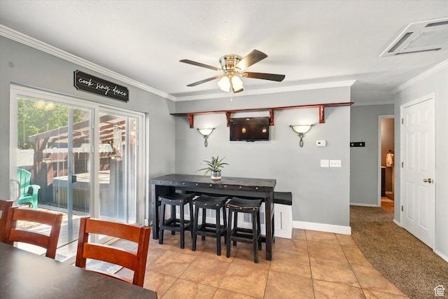 dining area featuring crown molding, ceiling fan, light tile patterned flooring, and baseboards