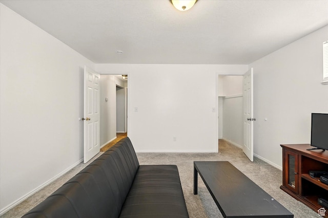 living room featuring carpet and baseboards