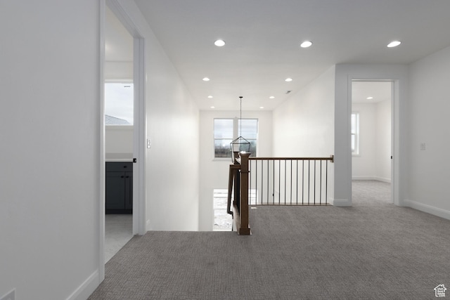 corridor featuring carpet, recessed lighting, an upstairs landing, and baseboards