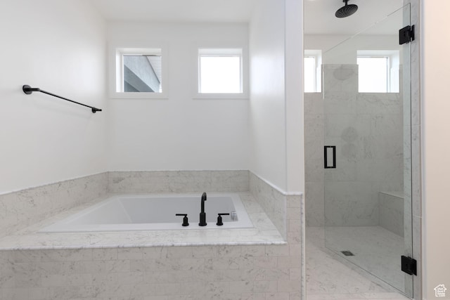 bathroom with a stall shower, healthy amount of natural light, and a garden tub