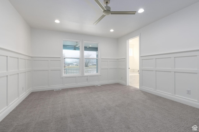 spare room with a decorative wall, ceiling fan, a wainscoted wall, carpet flooring, and recessed lighting