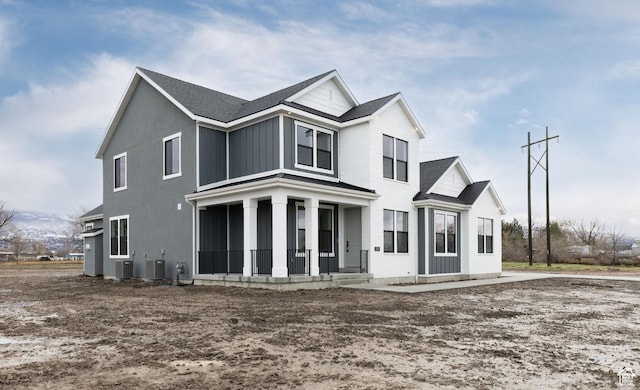 view of front of home featuring covered porch and cooling unit
