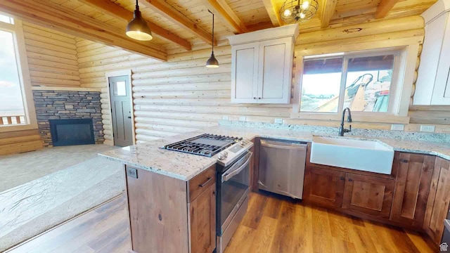 1982 S High Juniper Dr, Cedar City, UT 84720 - kitchen featuring stainless steel appliances, a sink, wood ceiling, rustic walls, and beamed ceiling