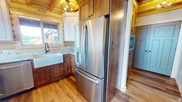 1982 S High Juniper Dr, Cedar City, UT 84720 - kitchen with appliances with stainless steel finishes, light wood-style floors, a sink, beam ceiling, and light stone countertops