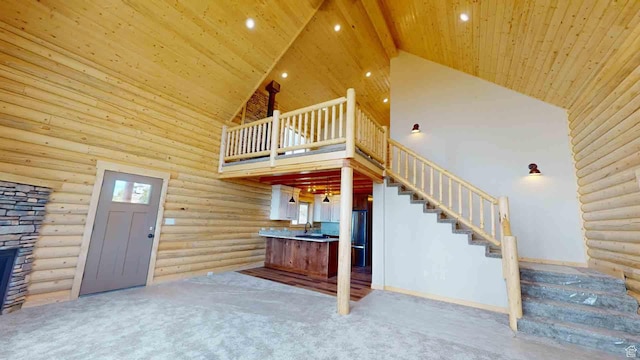 1982 S High Juniper Dr, Cedar City, UT 84720 - unfurnished living room featuring high vaulted ceiling, rustic walls, stairs, carpet floors, and recessed lighting