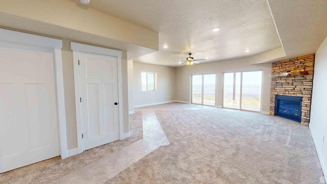 1982 S High Juniper Dr, Cedar City, UT 84720 - unfurnished living room with carpet floors, a ceiling fan, a fireplace, a textured ceiling, and recessed lighting
