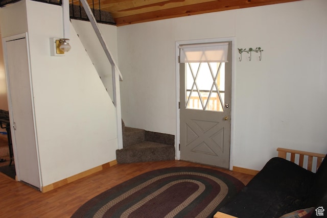 foyer entrance featuring stairway, wood finished floors, and baseboards