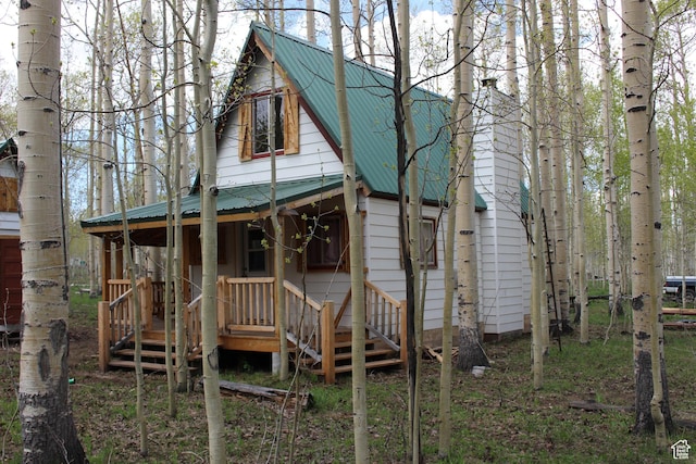 view of front of house featuring metal roof and a porch