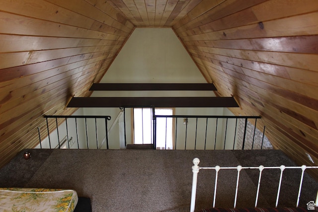 additional living space with wood walls and lofted ceiling