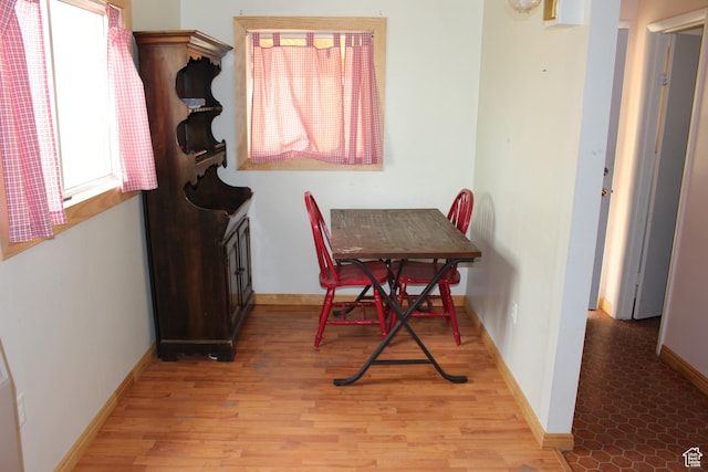 dining room with light wood-style floors and baseboards