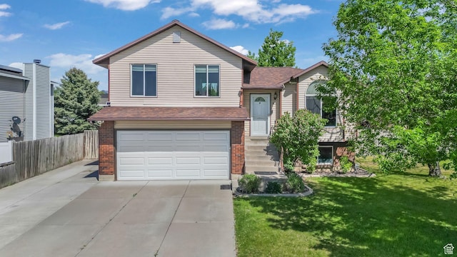 4812 S 3925 W, Roy, UT 84067 - tri-level home featuring brick siding, an attached garage, concrete driveway, and a shingled roof