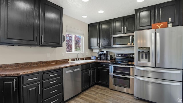 4812 S 3925 W, Roy, UT 84067 - kitchen with stainless steel appliances, a sink, dark cabinets, dark countertops, and recessed lighting