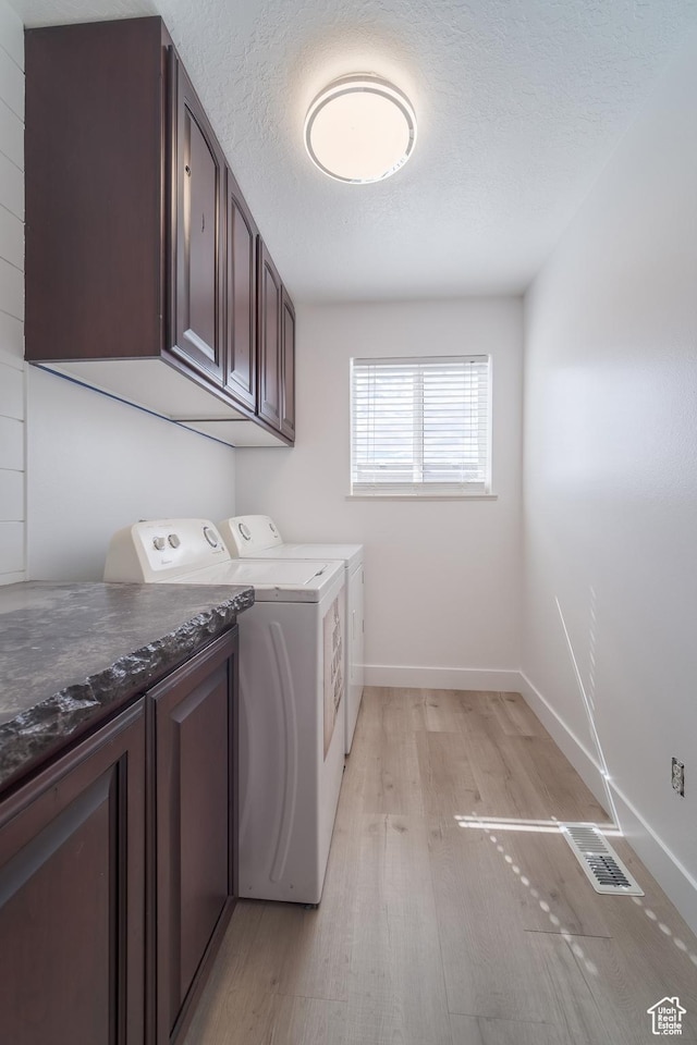 320 E 100 N, Manti, UT 84642 - laundry room featuring washer and dryer, baseboards, light wood-style floors, cabinet space, and a textured ceiling
