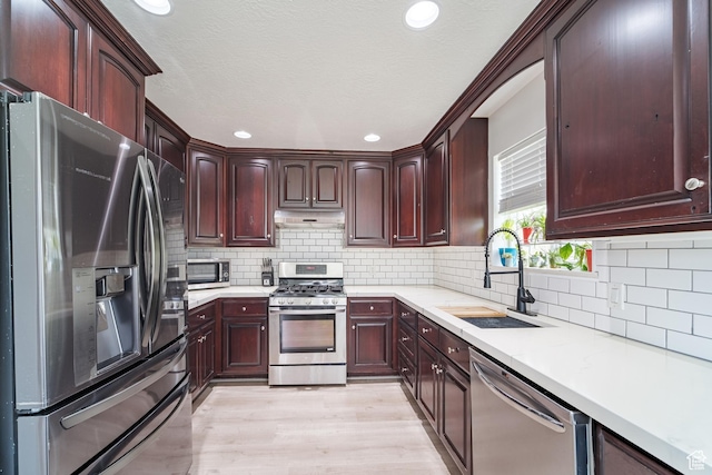 320 E 100 N, Manti, UT 84642 - kitchen featuring appliances with stainless steel finishes, under cabinet range hood, a sink, light countertops, and recessed lighting