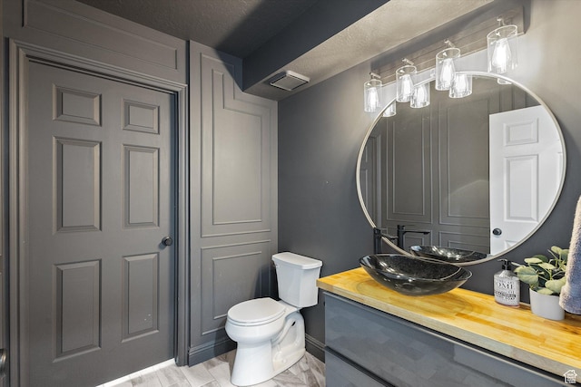 4962 S Glasmann Way S, Ogden, UT 84403 - bathroom featuring toilet, baseboards, and vanity