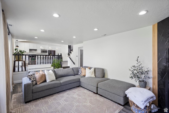 4962 S Glasmann Way S, Ogden, UT 84403 - living area with recessed lighting, light wood finished floors, stairs, and a textured ceiling