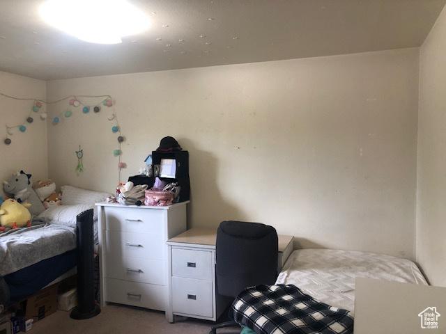 bedroom featuring light carpet