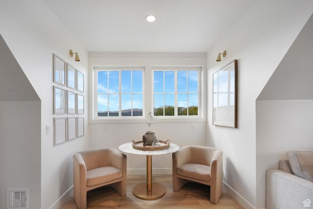 sitting room with baseboards, light wood-style flooring, and recessed lighting