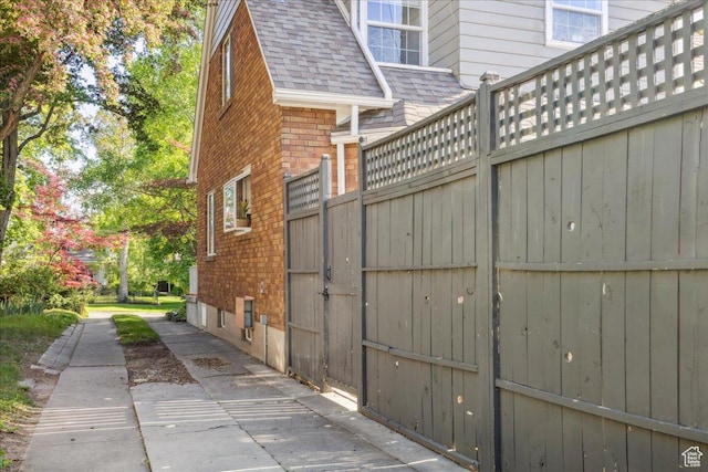 1225 E 700 S, Salt Lake City, UT 84102 - view of home's exterior featuring brick siding, roof with shingles, and fence