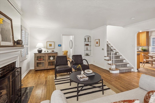 1225 E 700 S, Salt Lake City, UT 84102 - living room with crown molding, arched walkways, stairs, wood finished floors, and a fireplace with flush hearth