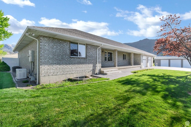 860 S 720 W, Glenwood, UT 84730 - view of front of house featuring brick siding, a front yard, an outbuilding, and driveway