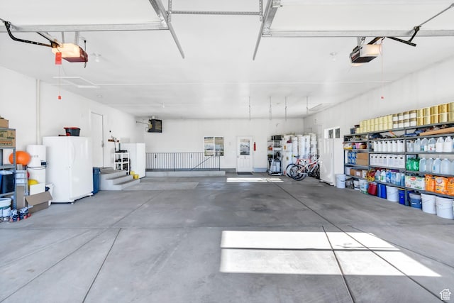 860 S 720 W, Glenwood, UT 84730 - garage with a garage door opener and freestanding refrigerator
