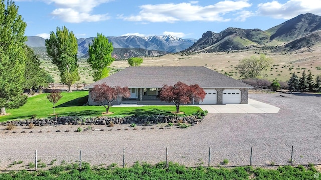 860 S 720 W, Glenwood, UT 84730 - view of front of house with a garage, concrete driveway, a front yard, and a mountain view