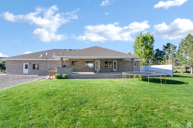 860 S 720 W, Glenwood, UT 84730 - back of property featuring a trampoline, brick siding, a yard, and roof with shingles