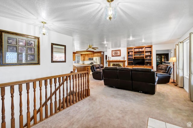860 S 720 W, Glenwood, UT 84730 - living room with light carpet, a tiled fireplace, and a ceiling fan