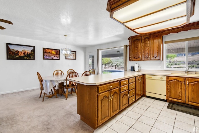 860 S 720 W, Glenwood, UT 84730 - kitchen with dishwasher, a sink, a peninsula, light countertops, and brown cabinets