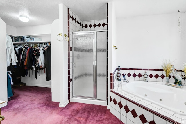 860 S 720 W, Glenwood, UT 84730 - full bathroom with a stall shower, a walk in closet, a tub with jets, baseboards, and a textured ceiling