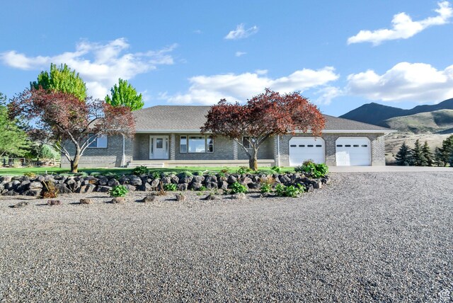 860 S 720 W, Glenwood, UT 84730 - ranch-style home with brick siding, a garage, driveway, and a mountain view