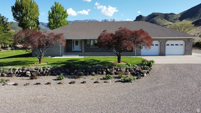 860 S 720 W, Glenwood, UT 84730 - view of front of property featuring driveway, a garage, a mountain view, a front yard, and brick siding