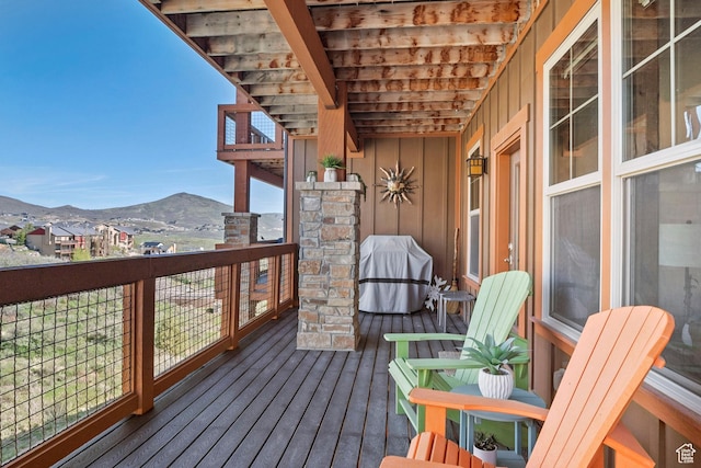 wooden deck with a mountain view and grilling area