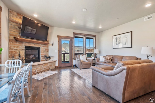 living area with hardwood / wood-style floors, a fireplace, and recessed lighting