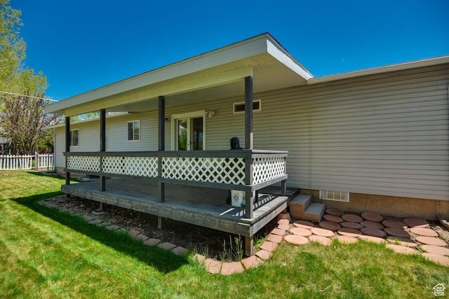 entrance to property featuring a wooden deck and crawl space