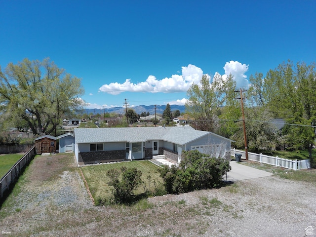 view of front of home with concrete driveway, a mountain view, and an attached garage