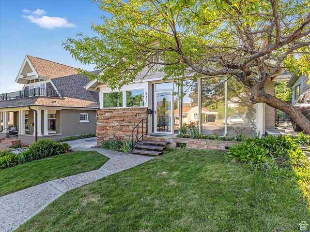 331 N K St, Salt Lake City, UT 84103 - view of front of house with a balcony, a front lawn, and roof with shingles