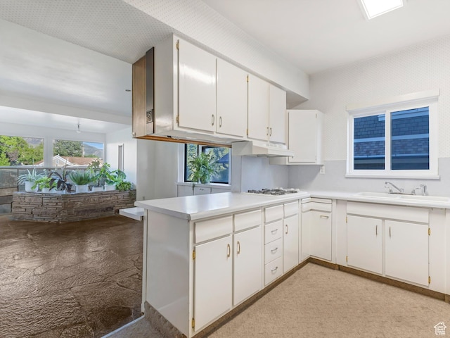 331 N K St, Salt Lake City, UT 84103 - kitchen with a sink, under cabinet range hood, light countertops, and white cabinets