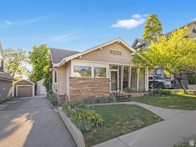 331 N K St, Salt Lake City, UT 84103 - view of front of house with a garage, a front yard, and an outdoor structure