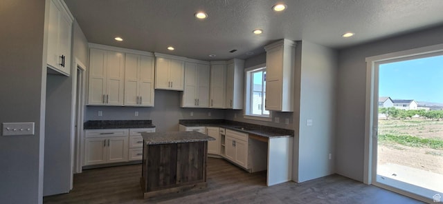 208 W 1300 S, Tremonton, UT 84337 - kitchen featuring a kitchen island, recessed lighting, dark wood-style flooring, dark countertops, and a textured ceiling